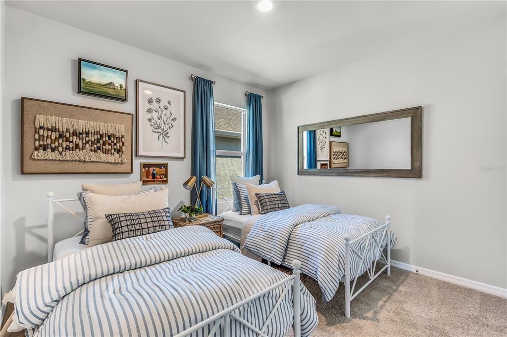 9489 Turtle Grass Circle Punta Gorda, FL 33950 - Photo 11 of 19 a bedroom with two beds and painting on the wall