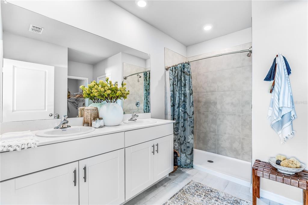 9489 Turtle Grass Circle Punta Gorda, FL 33950 - Photo 15 of 19 a bathroom with a double vanity sink and mirror