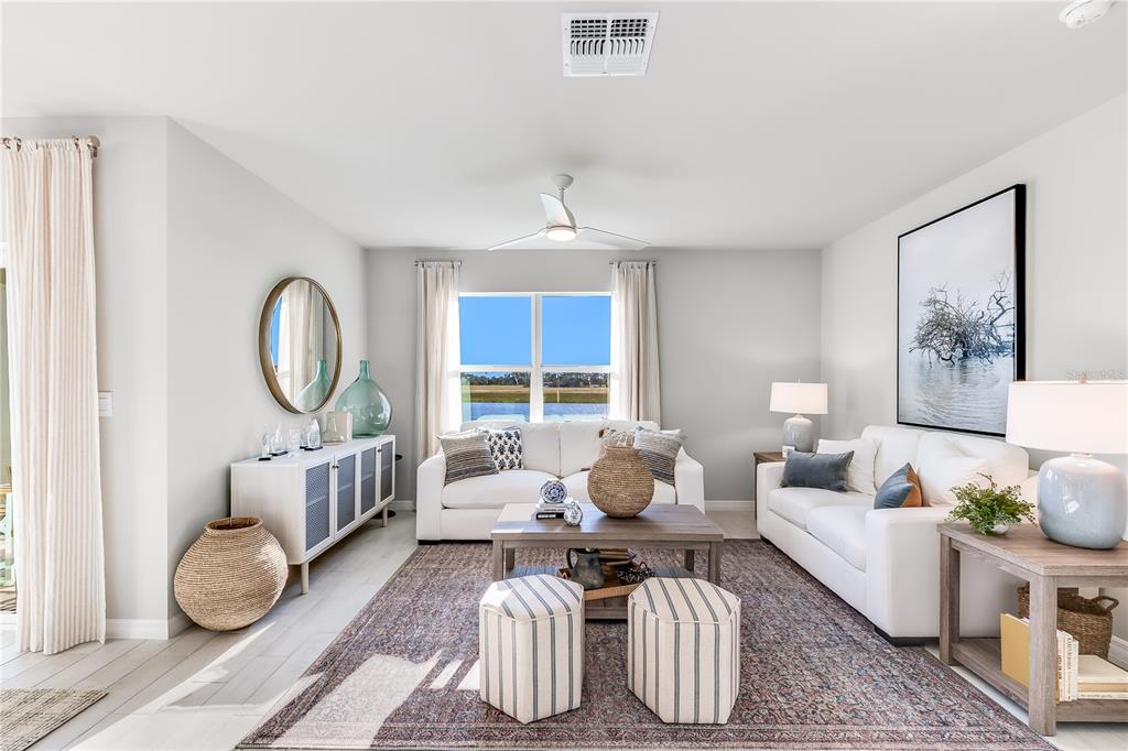 9489 Turtle Grass Circle Punta Gorda, FL 33950 - Photo 6 of 19 a living room with furniture a table and a large mirror
