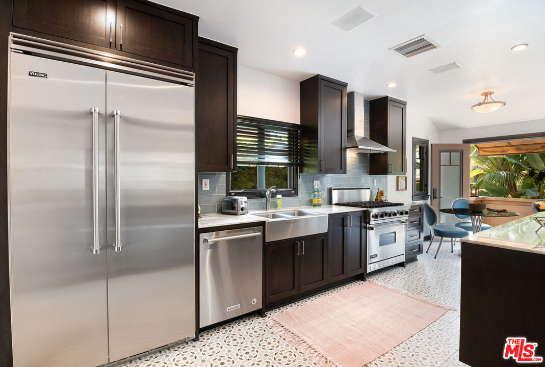 6331 Drexel Avenue Los Angeles, CA 90048 - Photo 18 of 37 a kitchen with stainless steel appliances granite countertop a sink stove and refrigerator