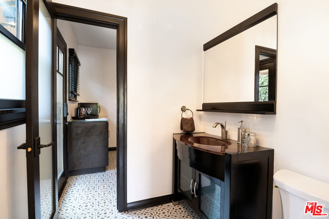 6331 Drexel Avenue Los Angeles, CA 90048 - Photo 22 of 37 a bathroom with a sink and a mirror