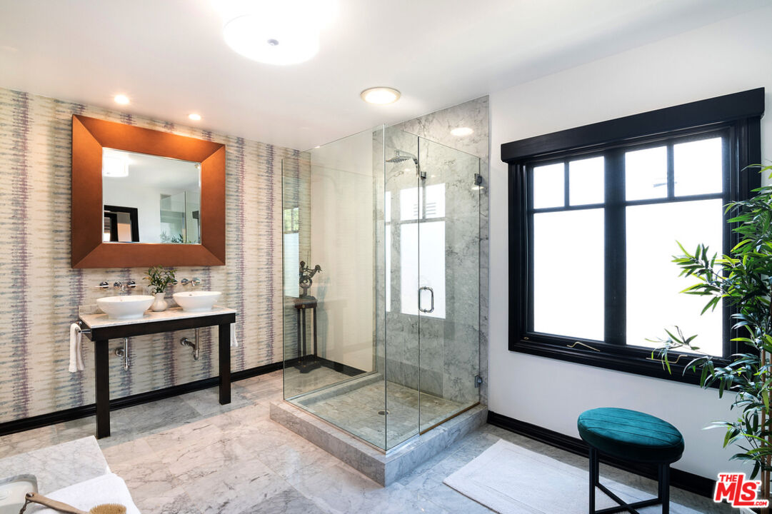 6331 Drexel Avenue Los Angeles, CA 90048 - Photo 32 of 37 a spacious bathroom with a granite countertop sink a mirror and a shower