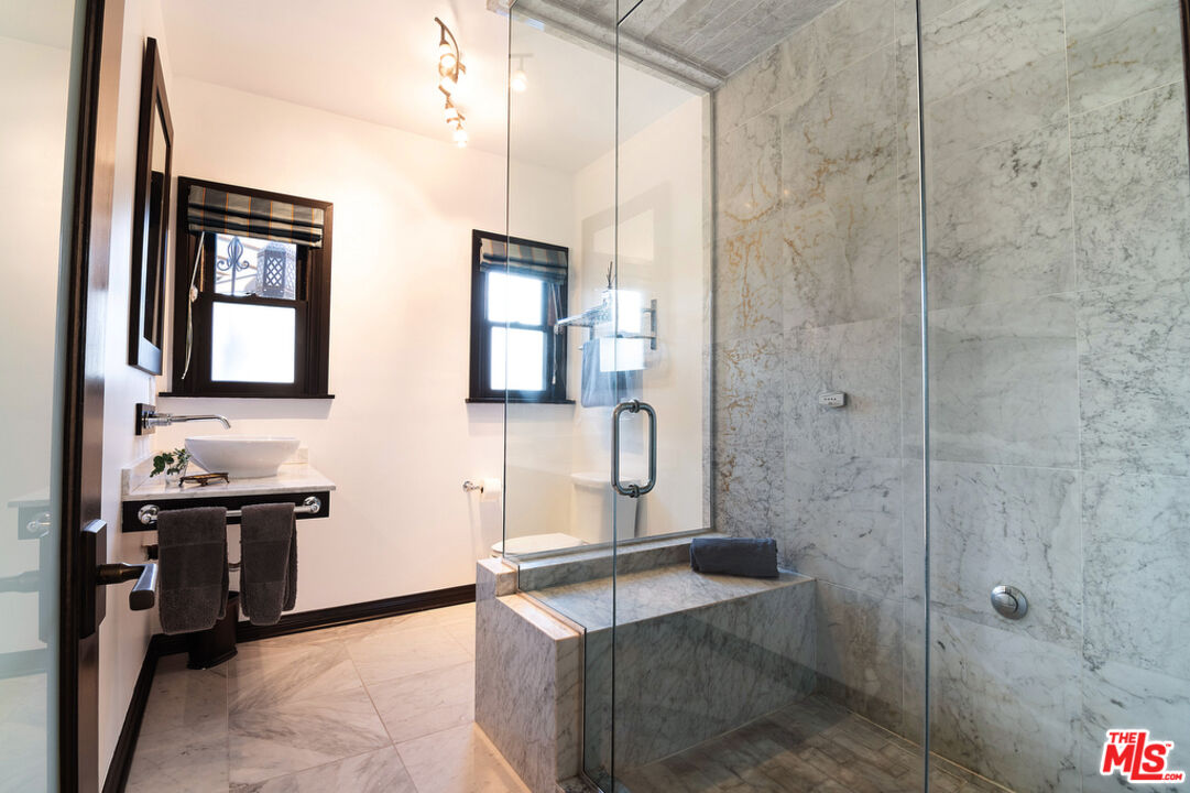 6331 Drexel Avenue Los Angeles, CA 90048 - Photo 35 of 37 a bathroom with a sink and a mirror