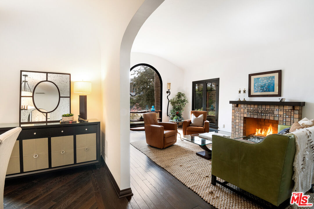6331 Drexel Avenue Los Angeles, CA 90048 - Photo 9 of 37 a living room with furniture a fireplace and a large window