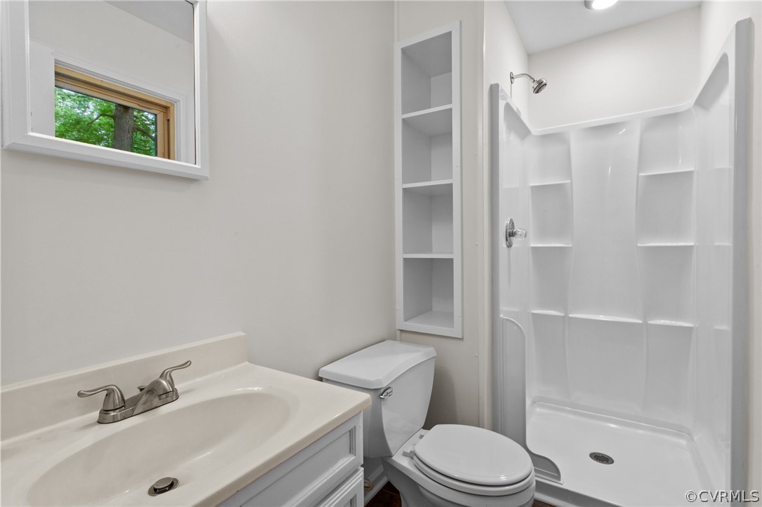 8601 Beaver Bridge Road Moseley, VA 23120 - Photo 20 of 42 a bathroom with a sink toilet and shower