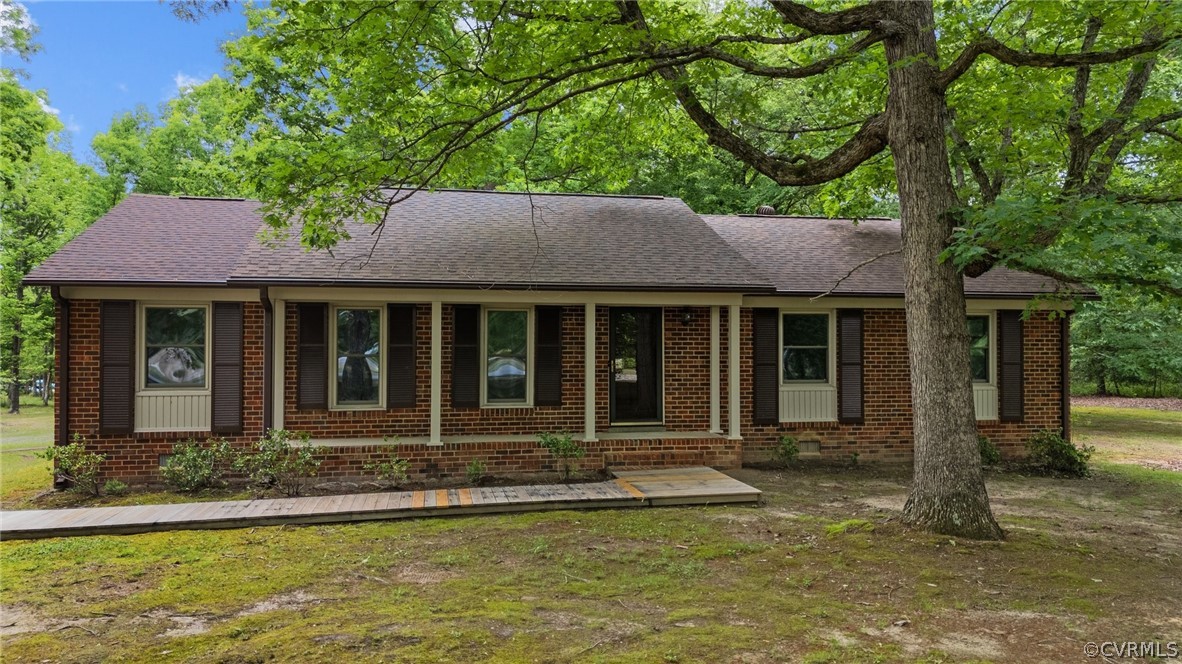 8601 Beaver Bridge Road Moseley, VA 23120 - Photo 2 of 42 a front view of a house with a garden and porch