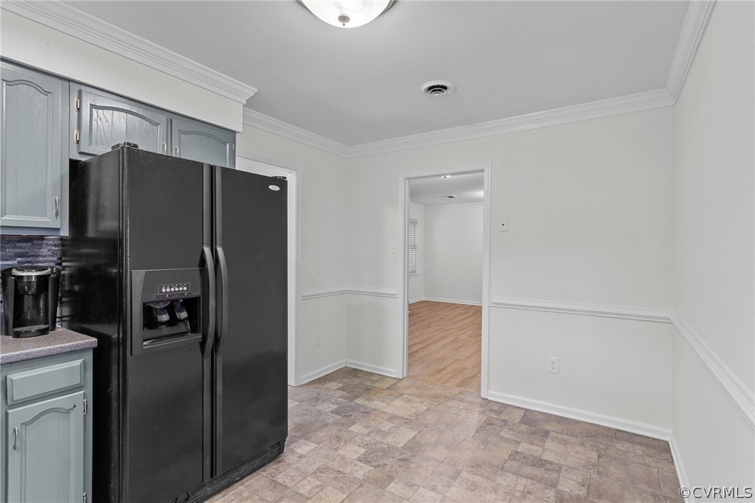 8601 Beaver Bridge Road Moseley, VA 23120 - Photo 9 of 42 a view of a refrigerator in kitchen and an empty room with wooden floor