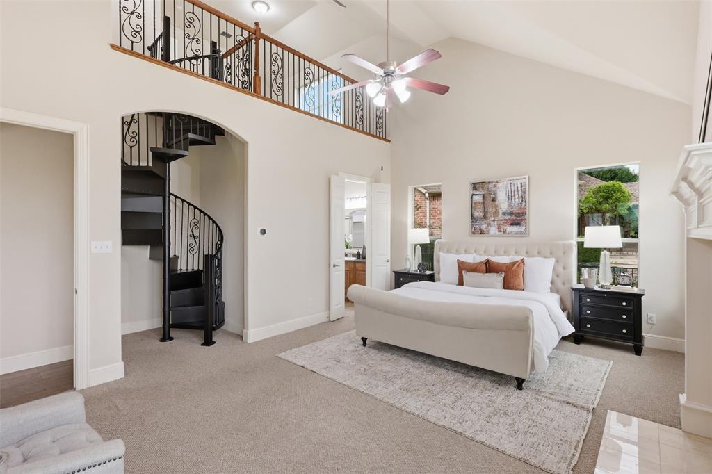 2841 Meadow Ridge Drive Prosper, TX 75078 - Photo 20 of 40 a bedroom with a large bed and a chandelier