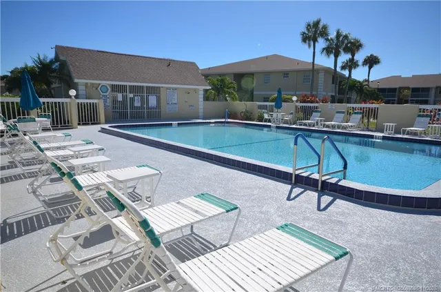 a swimming pool with outdoor seating and yard