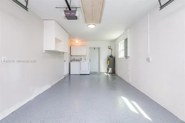 a view of a kitchen with a sink and refrigerator