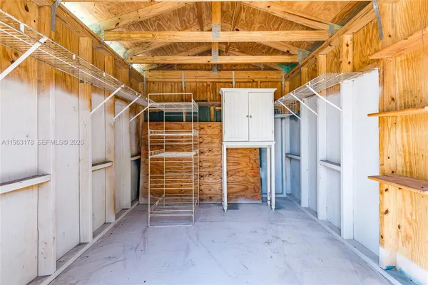 a view of empty room with wooden walls