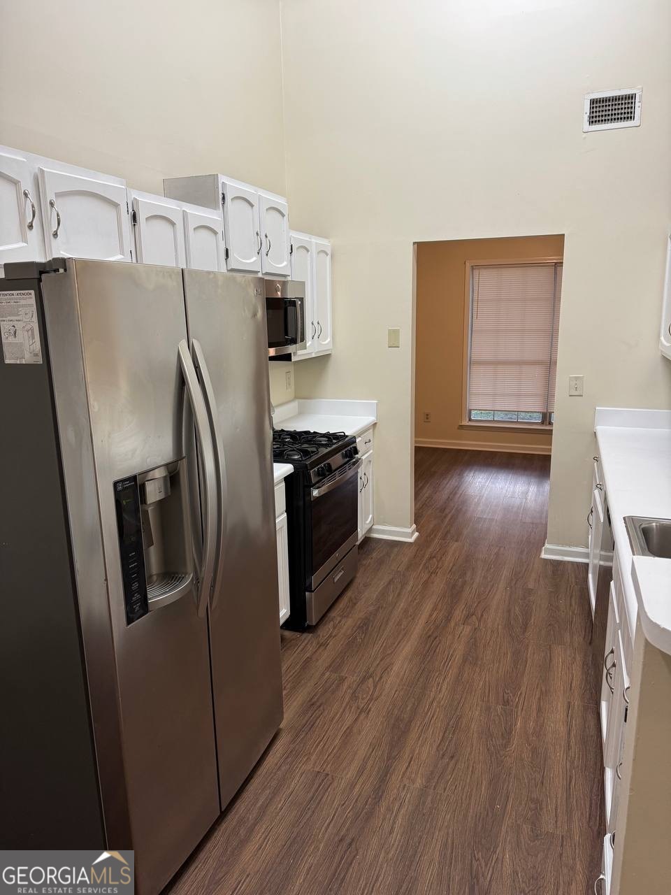3821 Rex Mill Square Rex, GA 30273 - Photo 33 of 51 a kitchen with stainless steel appliances a refrigerator a stove and wooden floor