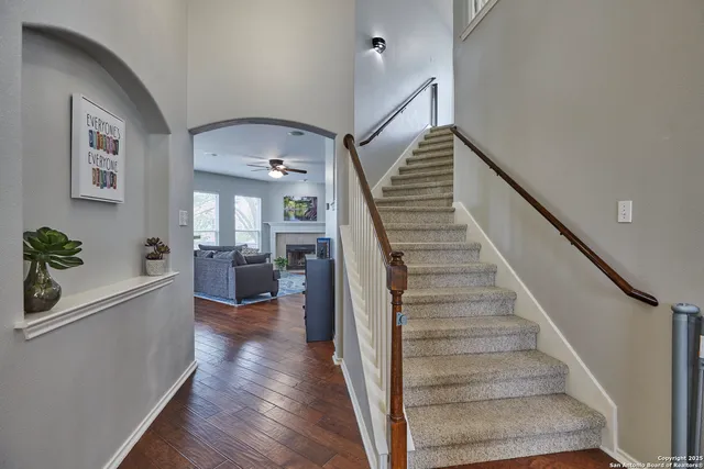 a view of entryway and hall with wooden floor