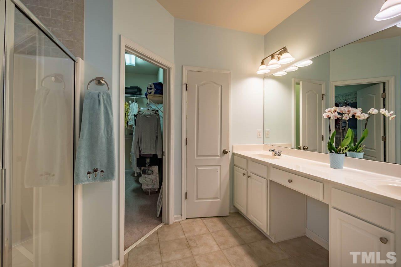 3400 Cathedral Bell Road Raleigh, NC 27614 - Photo 17 of 26 a spacious bathroom with a double vanity sink shower and a mirror