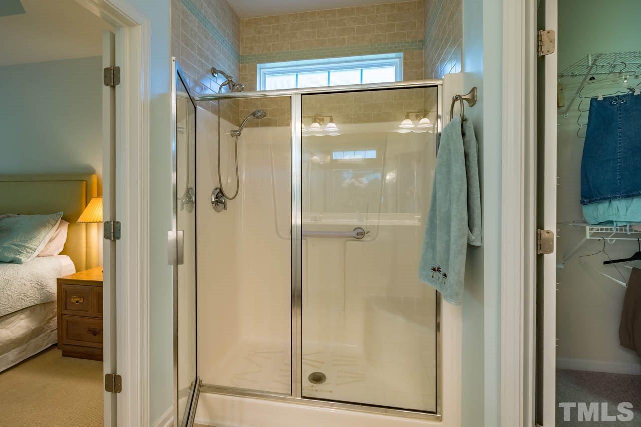 3400 Cathedral Bell Road Raleigh, NC 27614 - Photo 18 of 26 a bathroom with a glass shower door