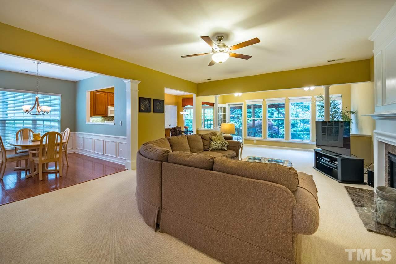 3400 Cathedral Bell Road Raleigh, NC 27614 - Photo 6 of 26 a living room with furniture a dining table and a flat screen tv with kitchen view