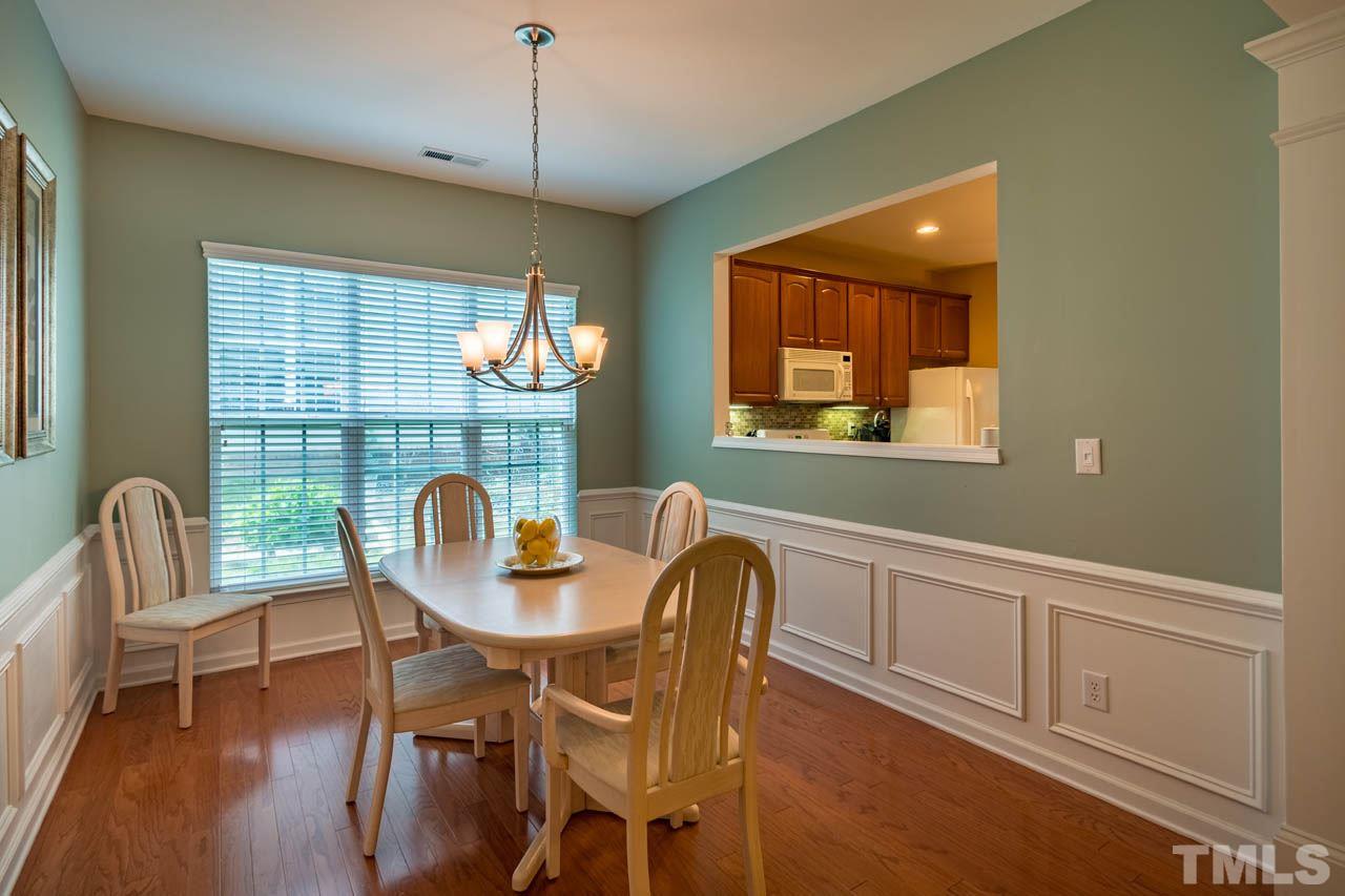 3400 Cathedral Bell Road Raleigh, NC 27614 - Photo 8 of 26 a dining room with furniture a window and wooden floor