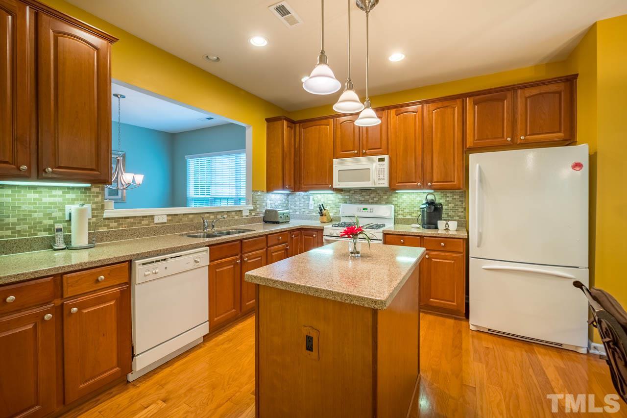 3400 Cathedral Bell Road Raleigh, NC 27614 - Photo 9 of 26 a kitchen with a sink a refrigerator a window and cabinets