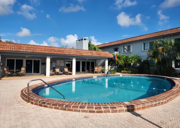 a view of a house with swimming pool and porch