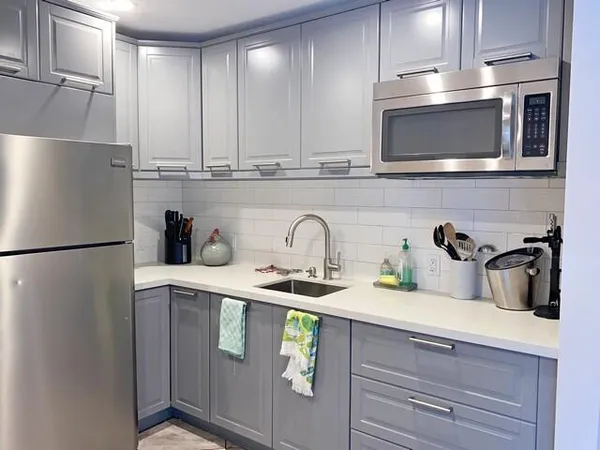 a kitchen with appliances a sink and cabinets
