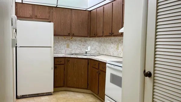 a kitchen with a refrigerator and a sink
