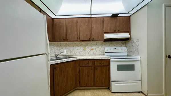 a kitchen with a sink a stove and cabinets