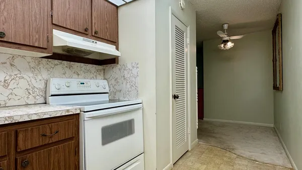 a kitchen with stainless steel appliances granite countertop a stove a microwave and a refrigerator