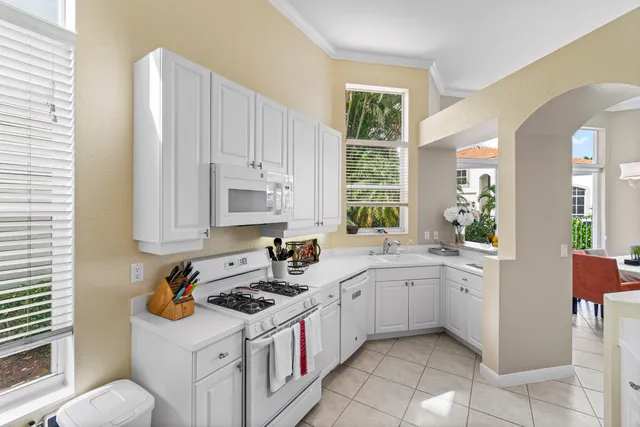 a kitchen with a sink stove and cabinets