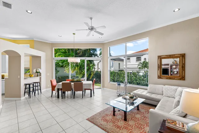 a living room with furniture and floor to ceiling windows