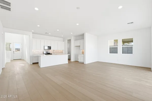 a view of kitchen with sink a microwave and refrigerator