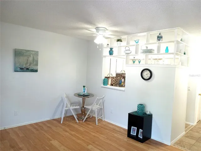 a workspace with wooden floor and a potted plant
