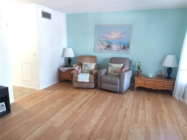 a kitchen with stainless steel appliances white cabinets and a refrigerator