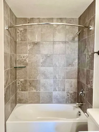 a bathroom with a bathtub and a shower