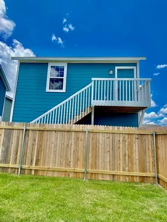 a view of a deck with wooden fence and a stairs