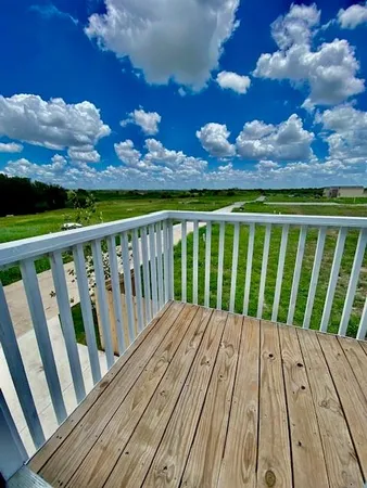 a view of balcony with wooden floor and city view