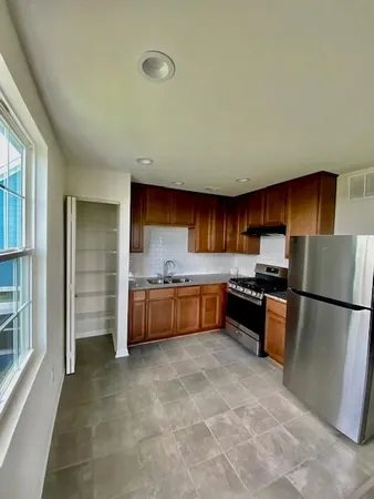 a large kitchen with a large stove top oven and refrigerator