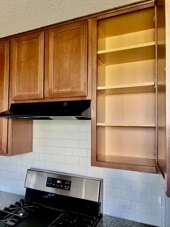 a kitchen with a stove and a cabinet