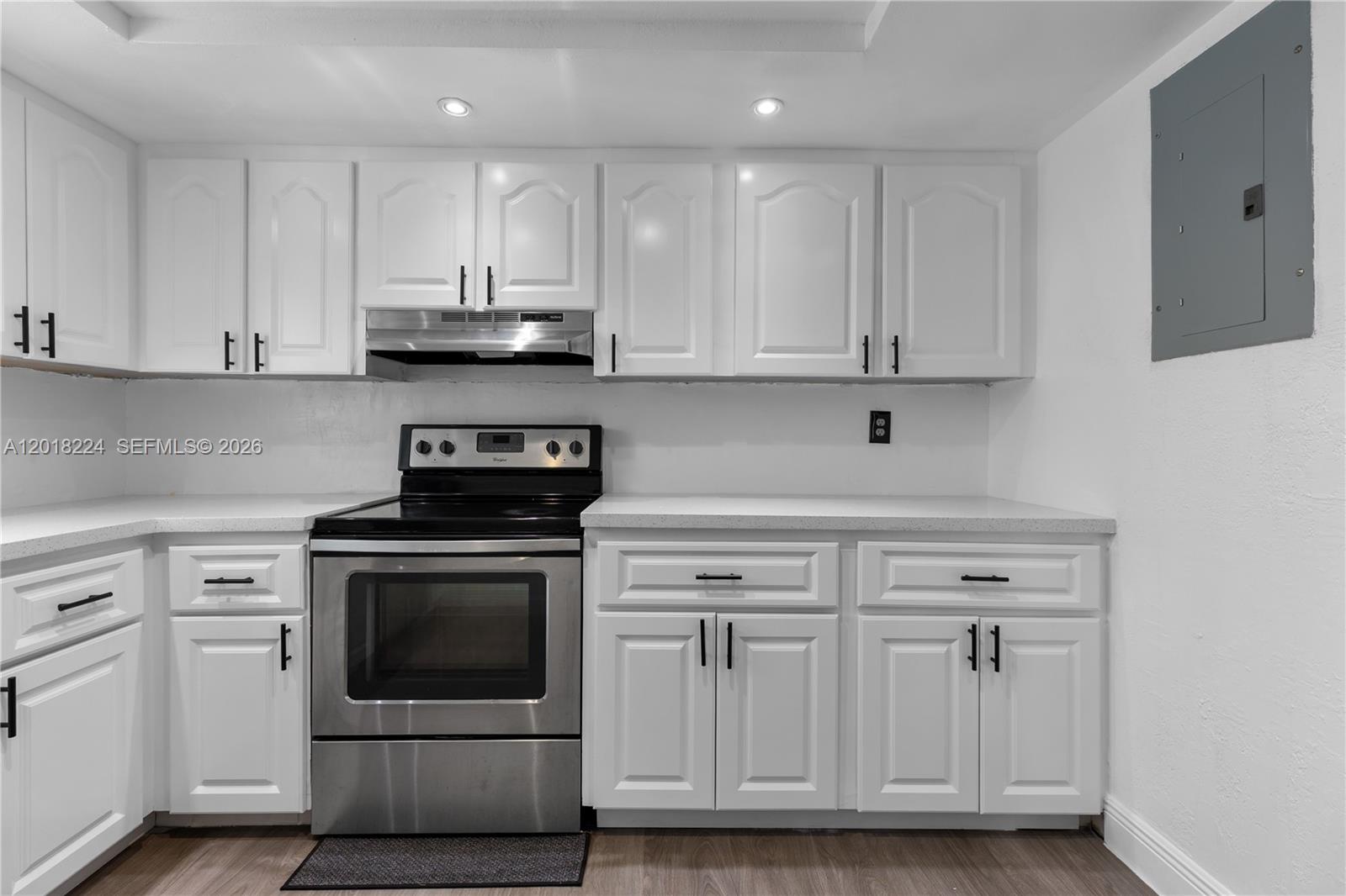 7958 Southwest 6th Street Pompano Beach, FL 33068 - Photo 19 of 57 a kitchen with white cabinets and appliances