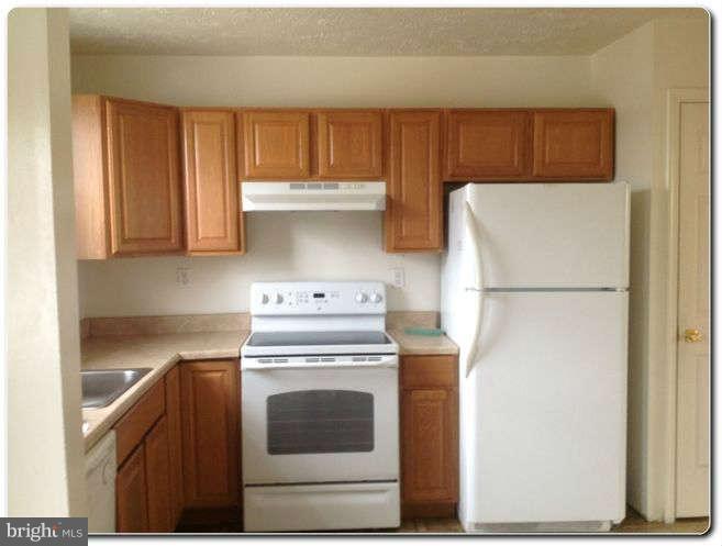 3303 Randall Road Suitland, MD 20746 - Photo 3 of 8 a kitchen with a stove top oven and refrigerator