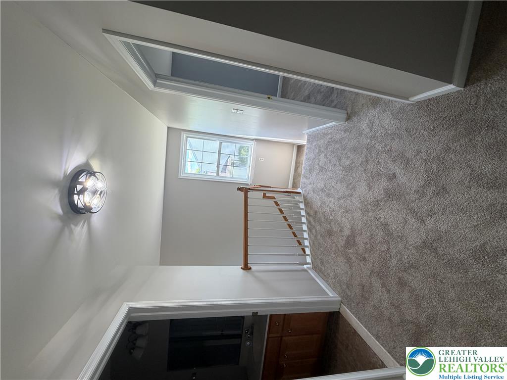 4157 Walter Road Bethlehem, PA 18020 - Photo 26 of 36 A window-lit hallway with carpeted flooring provides a functional and comfortable connection between rooms.