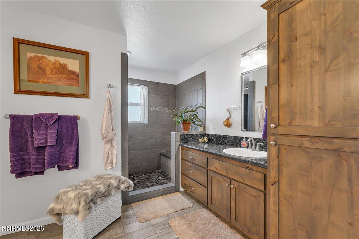1197 Sky Ridge Drive Fallon, NV 89406 - Photo 22 of 79 a bathroom with a double vanity sink mirror and shower
