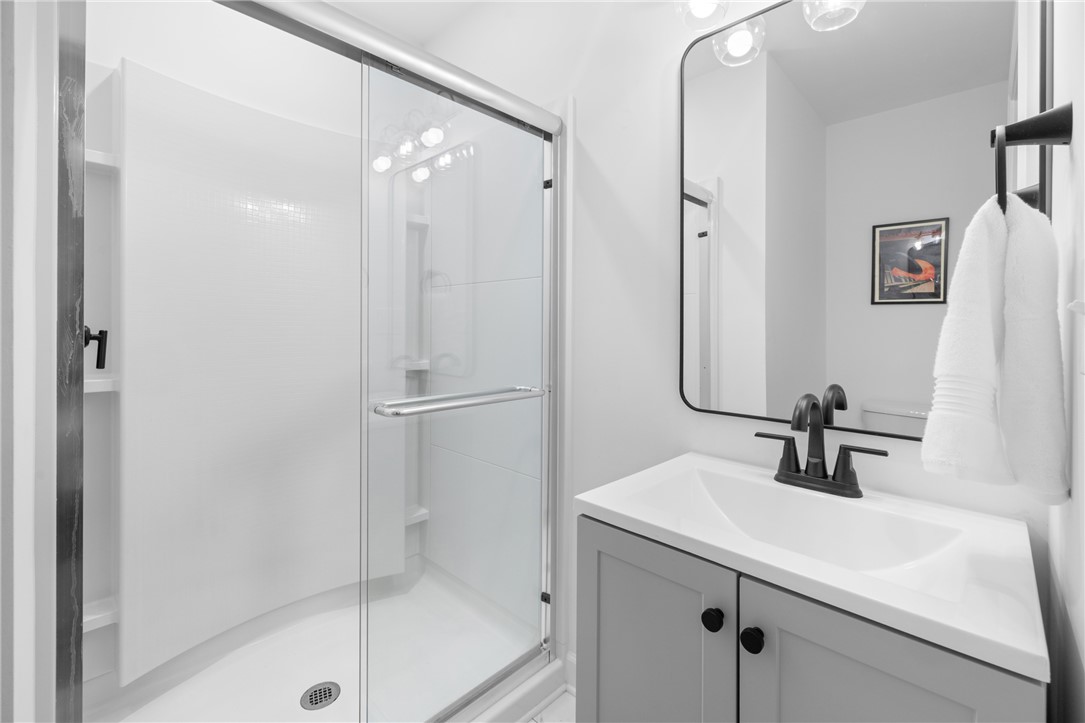 207 Brook Street Clemson, SC 29631 - Photo 24 of 39 Modern bathroom featuring a sleek vanity and a spacious glass-enclosed shower.
