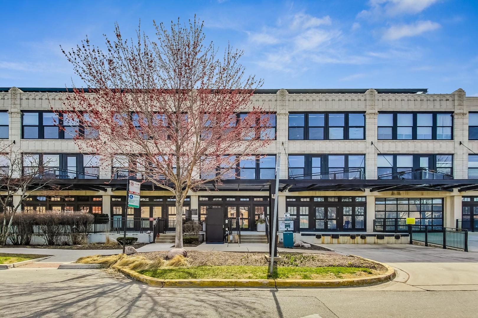 1151 West 14th Place, Unit 404 Chicago, IL 60608 - Photo 1 of 28 a view of building with a swimming pool
