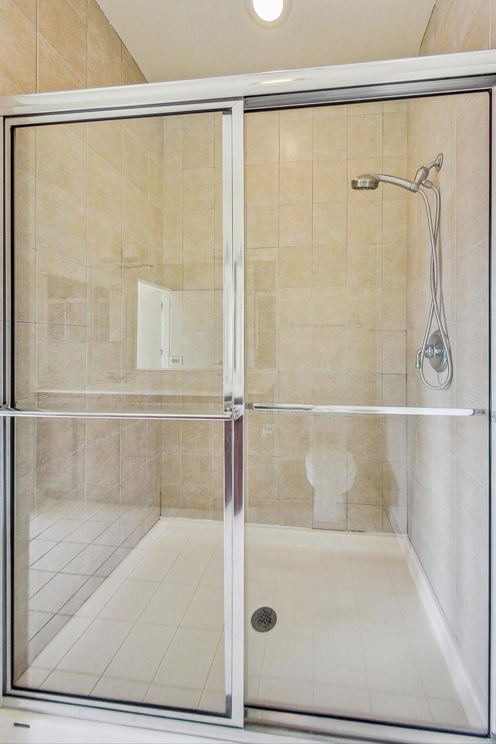 1151 West 14th Place, Unit 404 Chicago, IL 60608 - Photo 12 of 28 a bathroom with a glass shower door