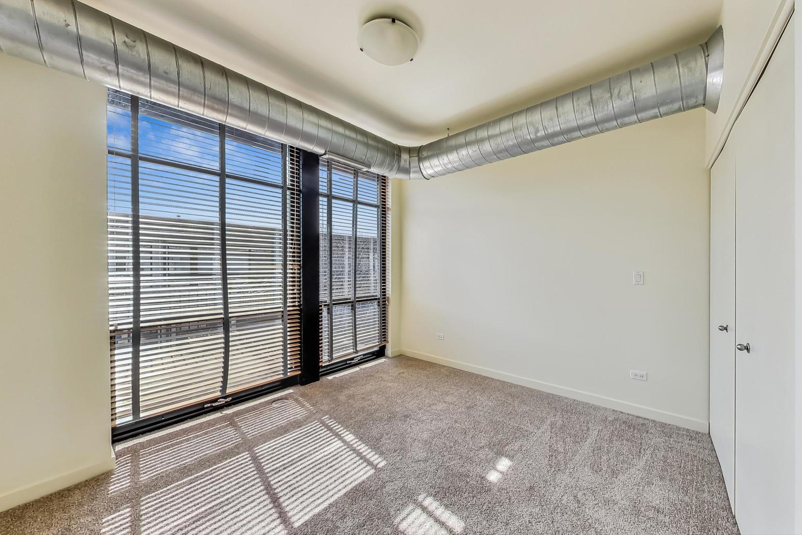 1151 West 14th Place, Unit 404 Chicago, IL 60608 - Photo 13 of 28 a view of an empty room with a window