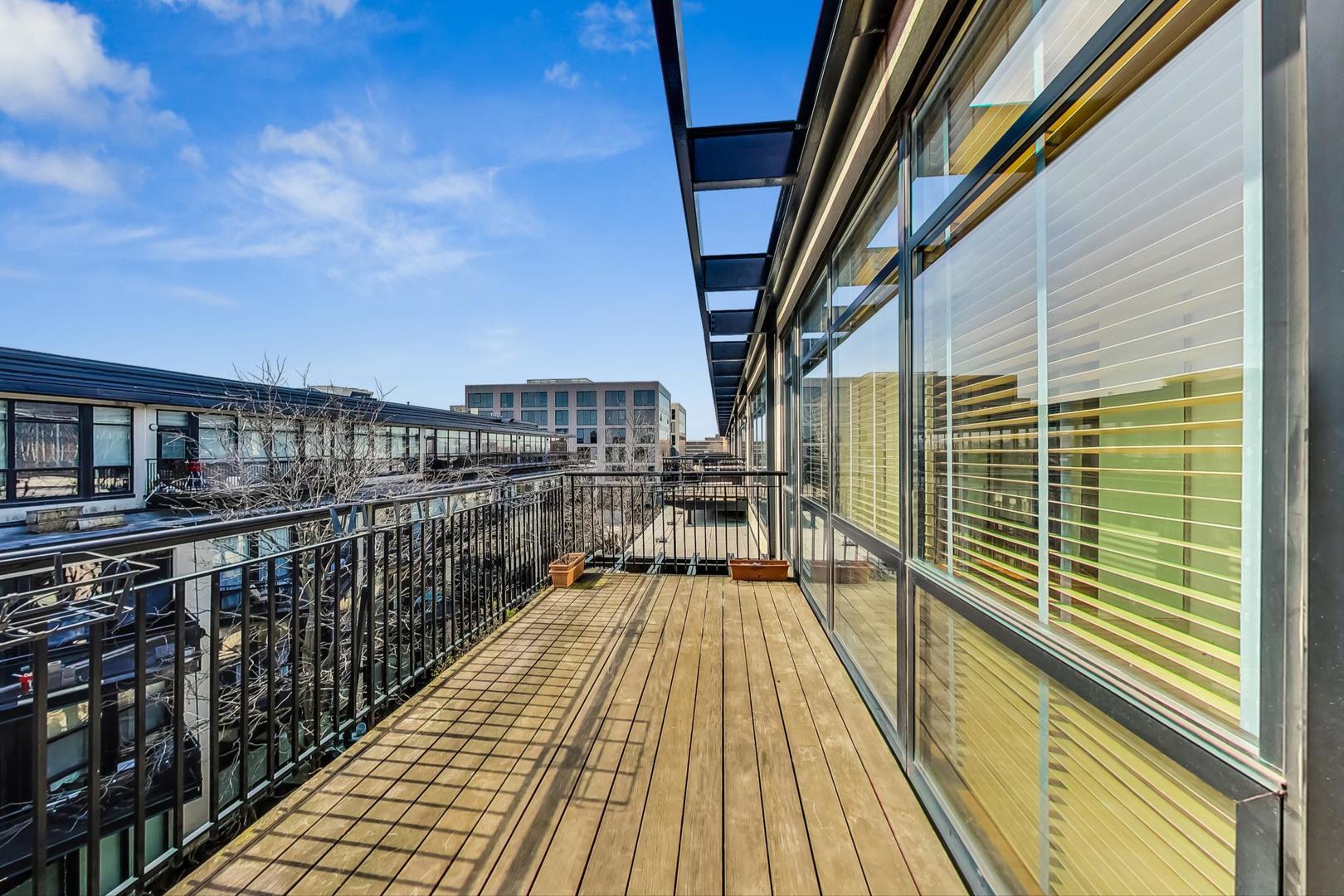 1151 West 14th Place, Unit 404 Chicago, IL 60608 - Photo 18 of 28 a view of balcony with wooden floor and seating space