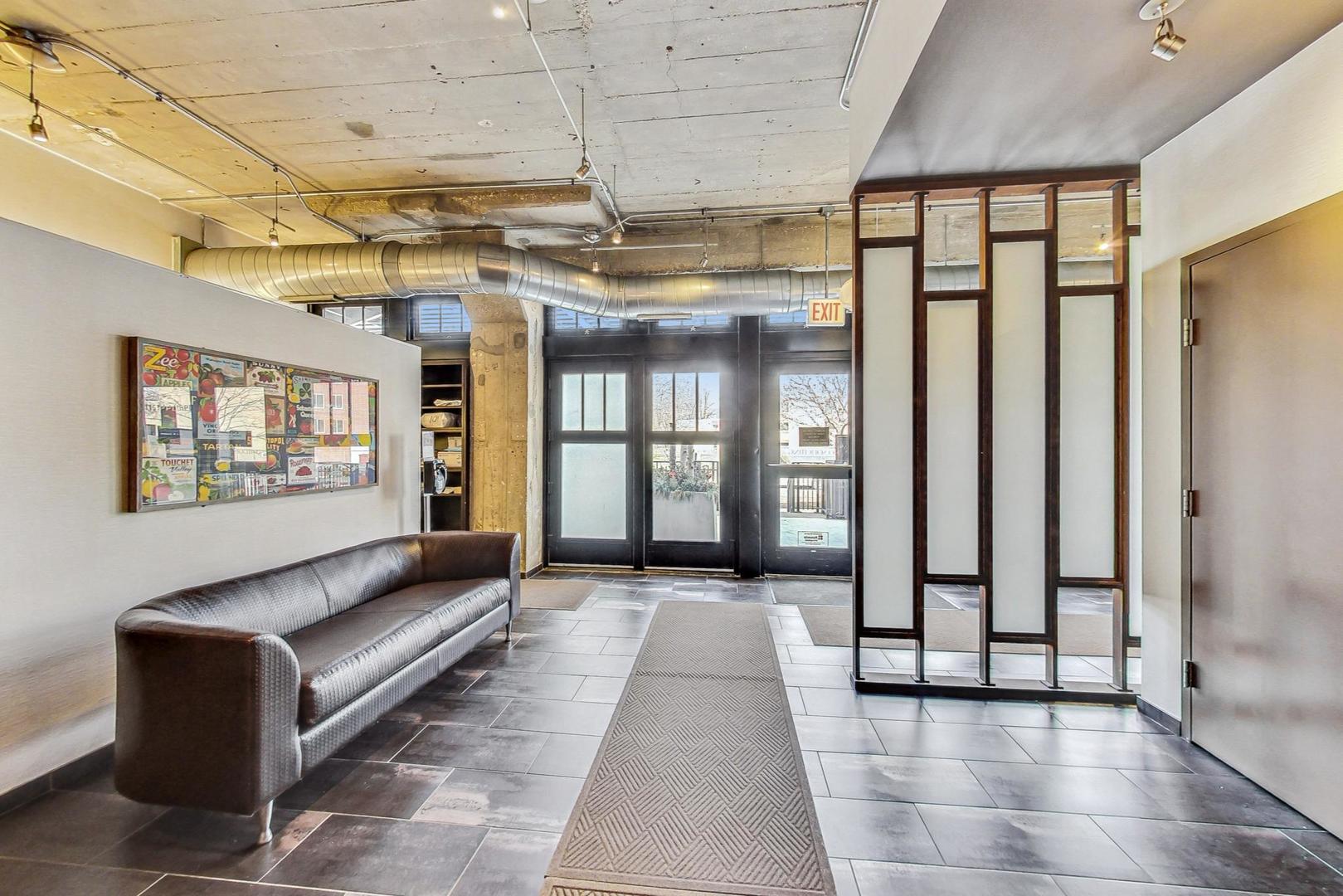 1151 West 14th Place, Unit 404 Chicago, IL 60608 - Photo 24 of 28 a view of a hallway with windows