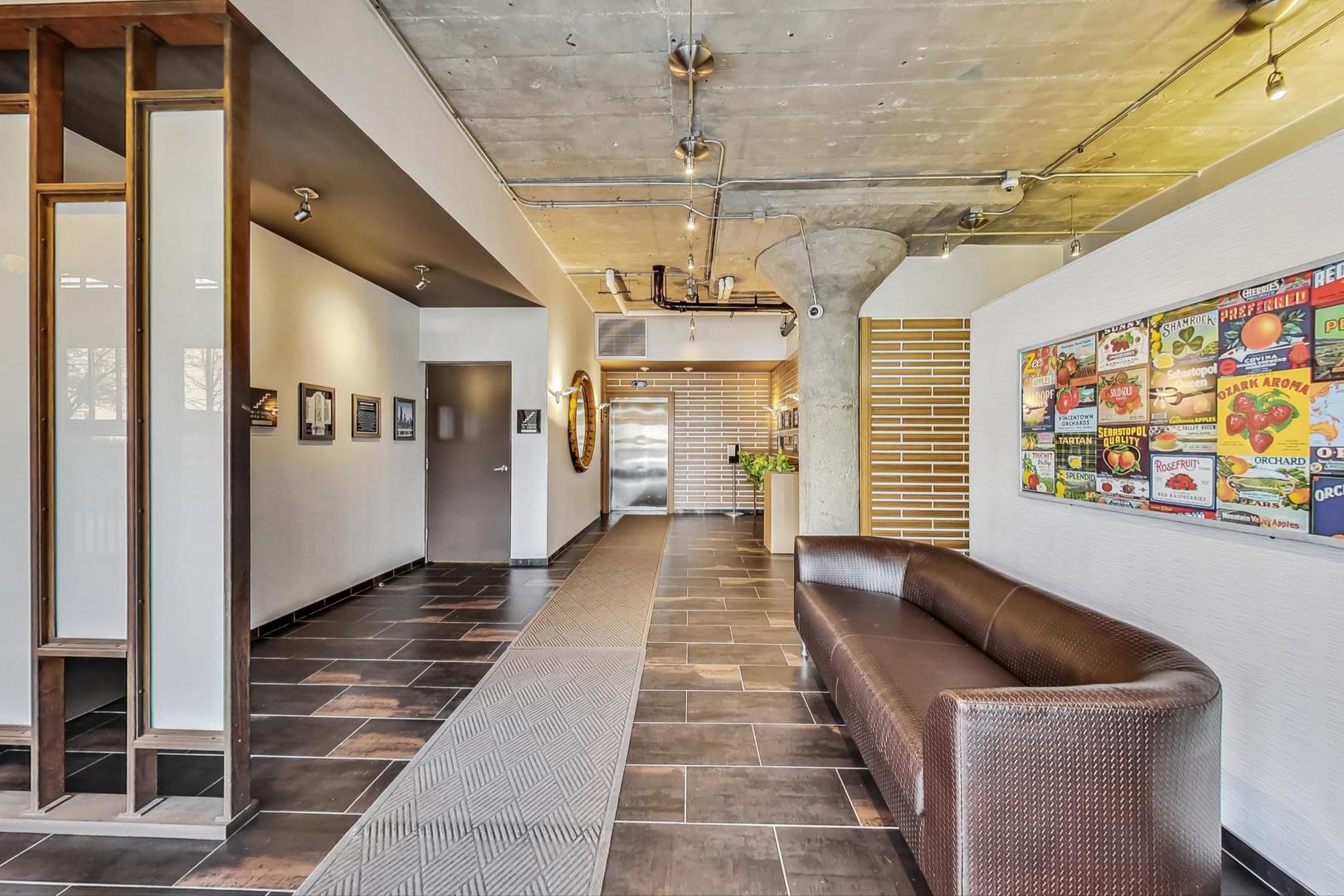 1151 West 14th Place, Unit 404 Chicago, IL 60608 - Photo 25 of 28 a hallway with furniture and a chandelier