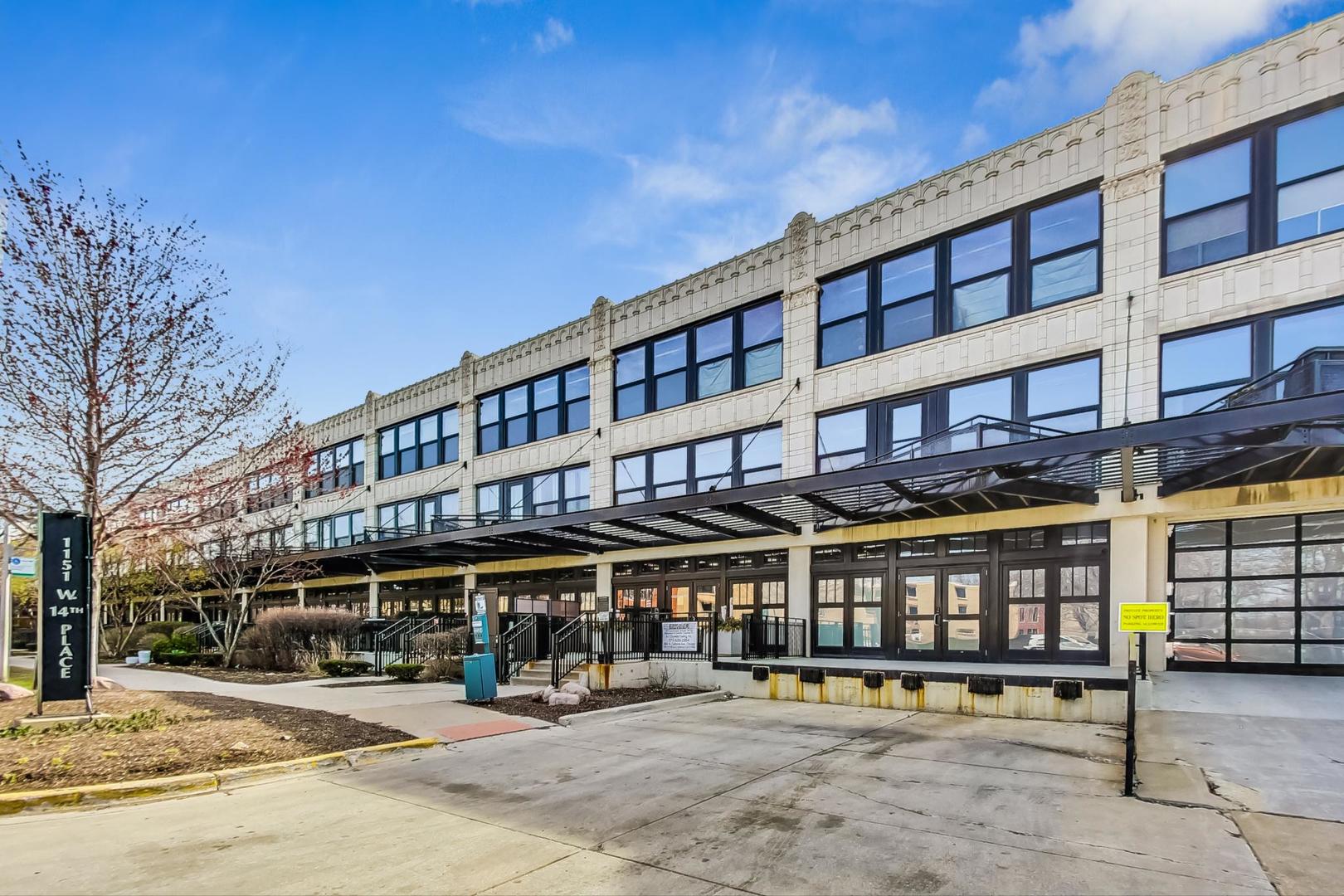 1151 West 14th Place, Unit 404 Chicago, IL 60608 - Photo 27 of 28 a view of a building with a balcony