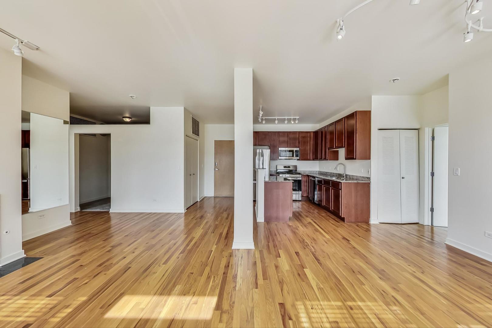 1151 West 14th Place, Unit 404 Chicago, IL 60608 - Photo 5 of 28 a view of kitchen with cabinets and wooden floor